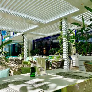 A motorized pergola covering a commercial dining area.
