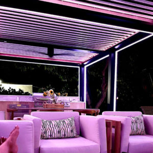 Purple seating on a patio underneath a motorized pergola.