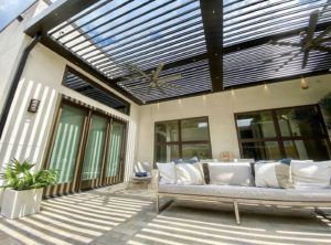 A residential patio covered by a luxury pergola with built-in fans.