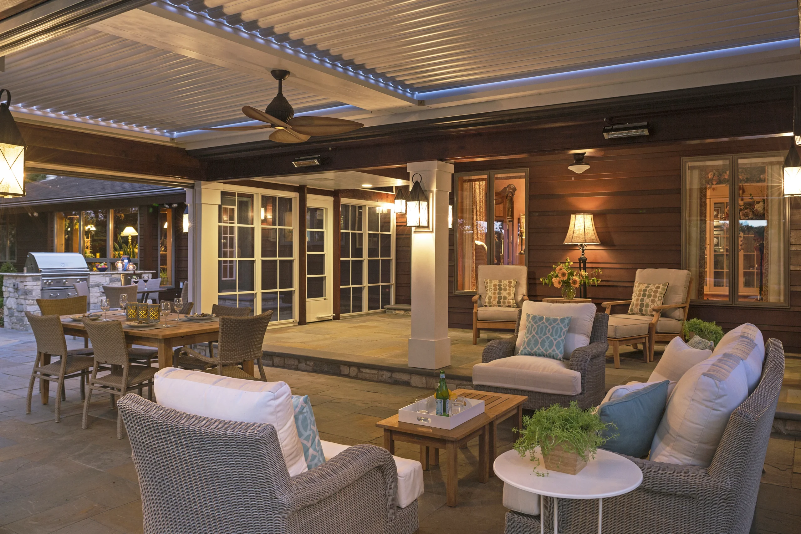 Covered outdoor living area with louvered aluminum roof at a South Florida residence