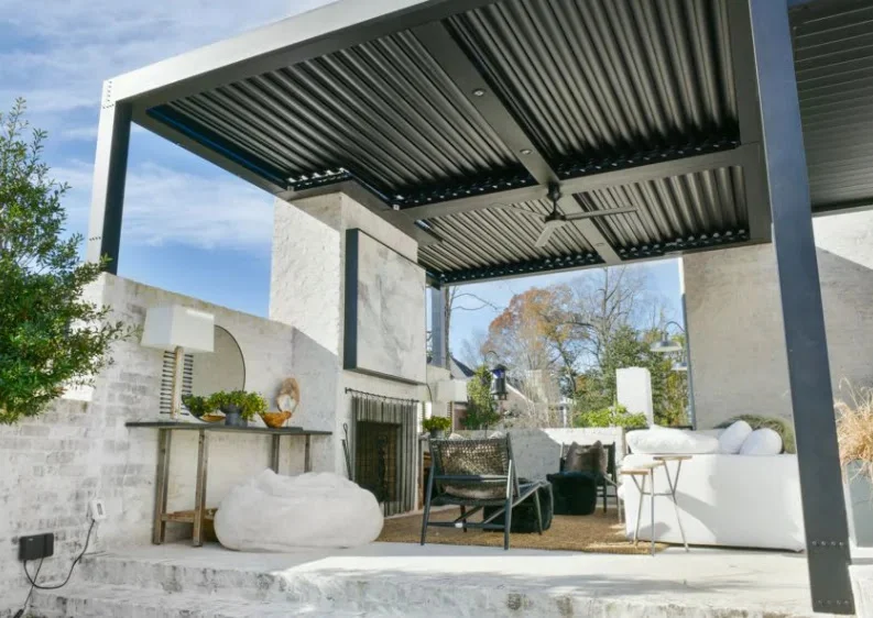 Shade sail vs pergola comparison: a louvered aluminum roof over a South Florida terrace