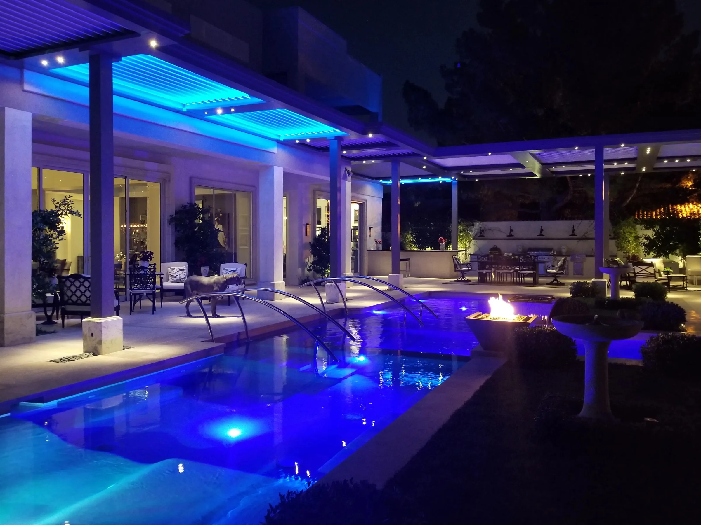 Poolside pergola sited between existing palms so no footing lands in a root plate