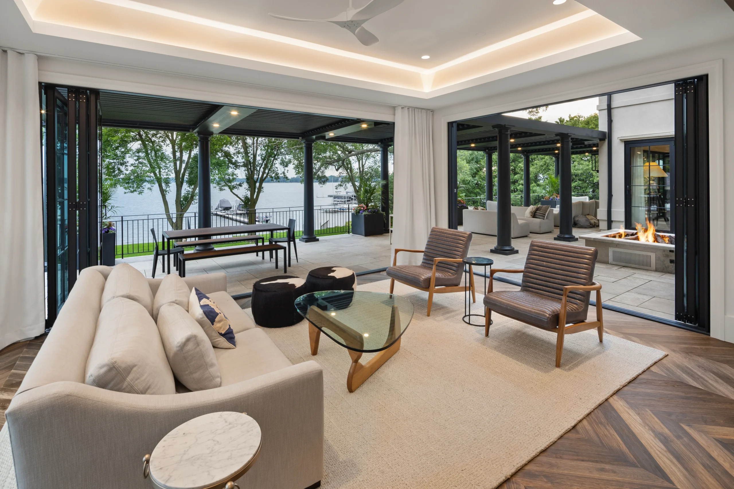 Interior of a new Florida home opening onto a covered louvered terrace overlooking the water