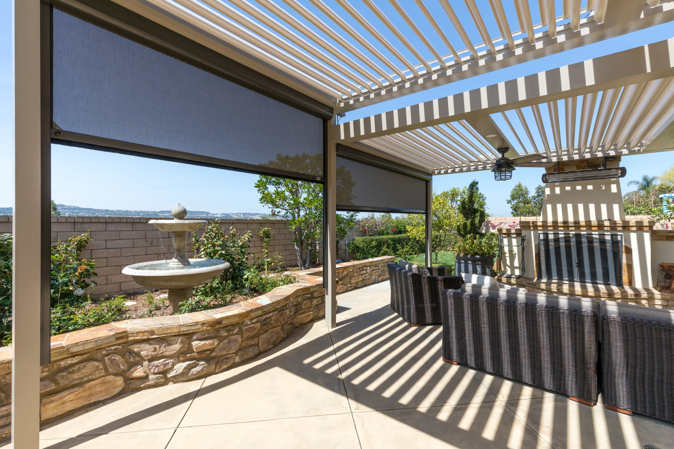 StruXure louvered pergola with motorized screens providing shade and privacy on a residential patio