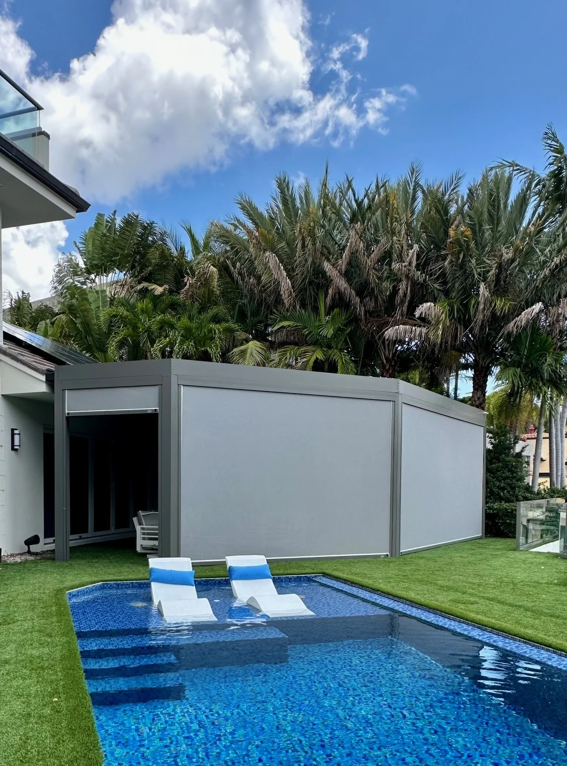 Motorized privacy screens deployed on a StruXure louvered pergola creating a private outdoor room