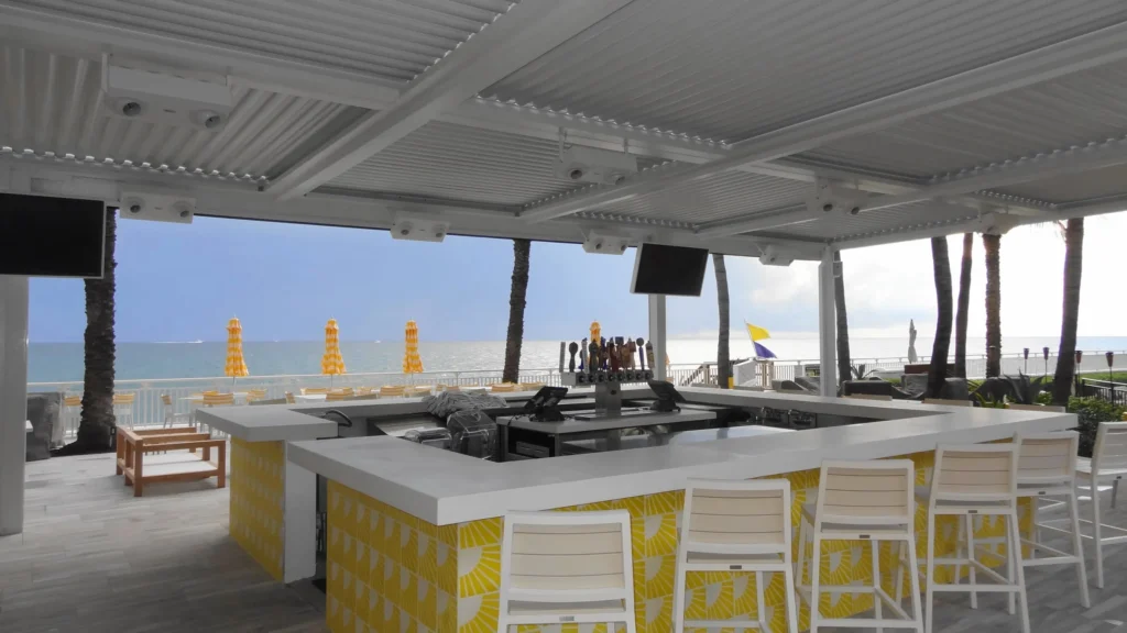 StruXure motorized louvered pergola over the beachfront bar at EAU Palm Beach Resort in South Florida