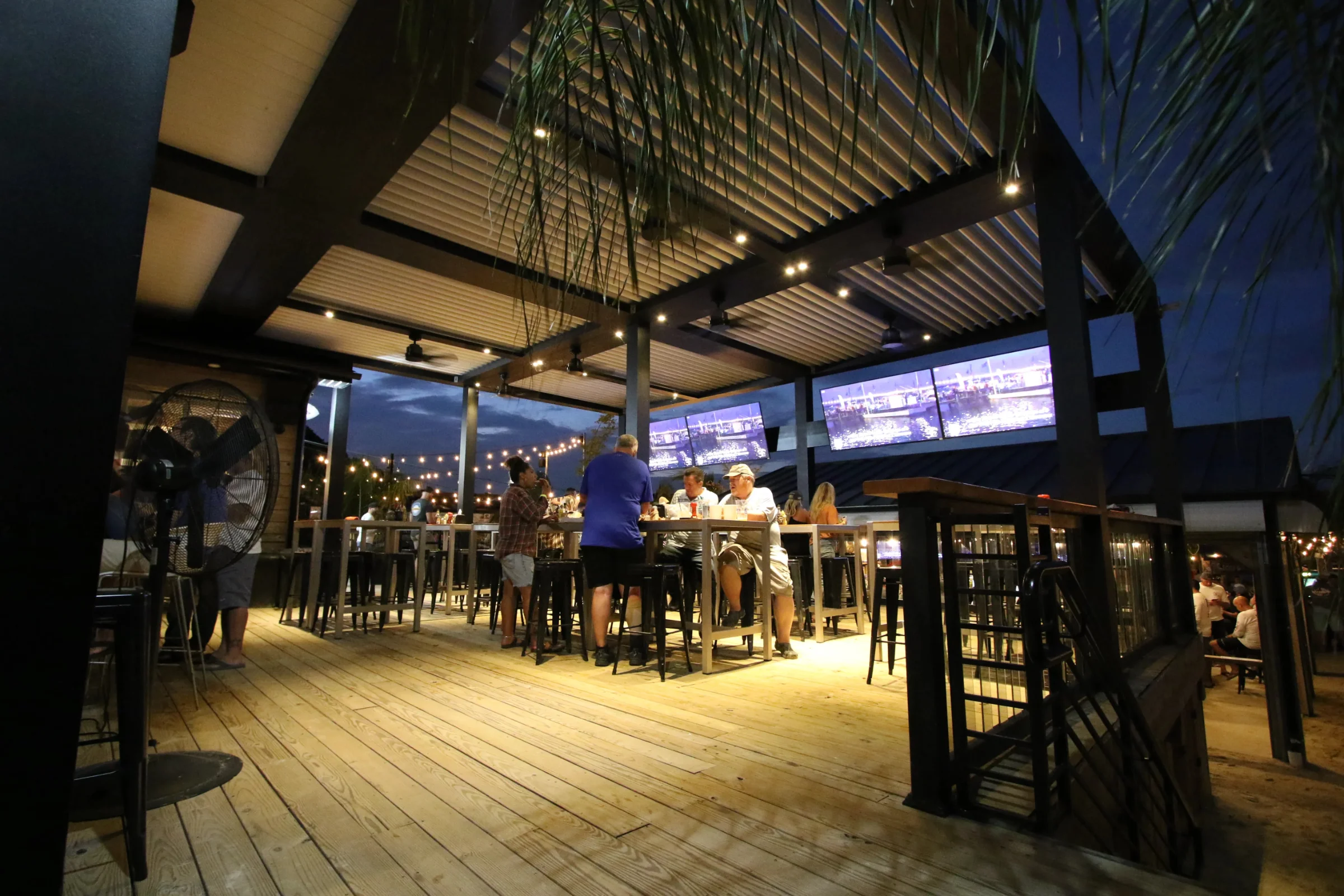 Aluminum louvered pergola structure on a rooftop amenity deck with skyline views