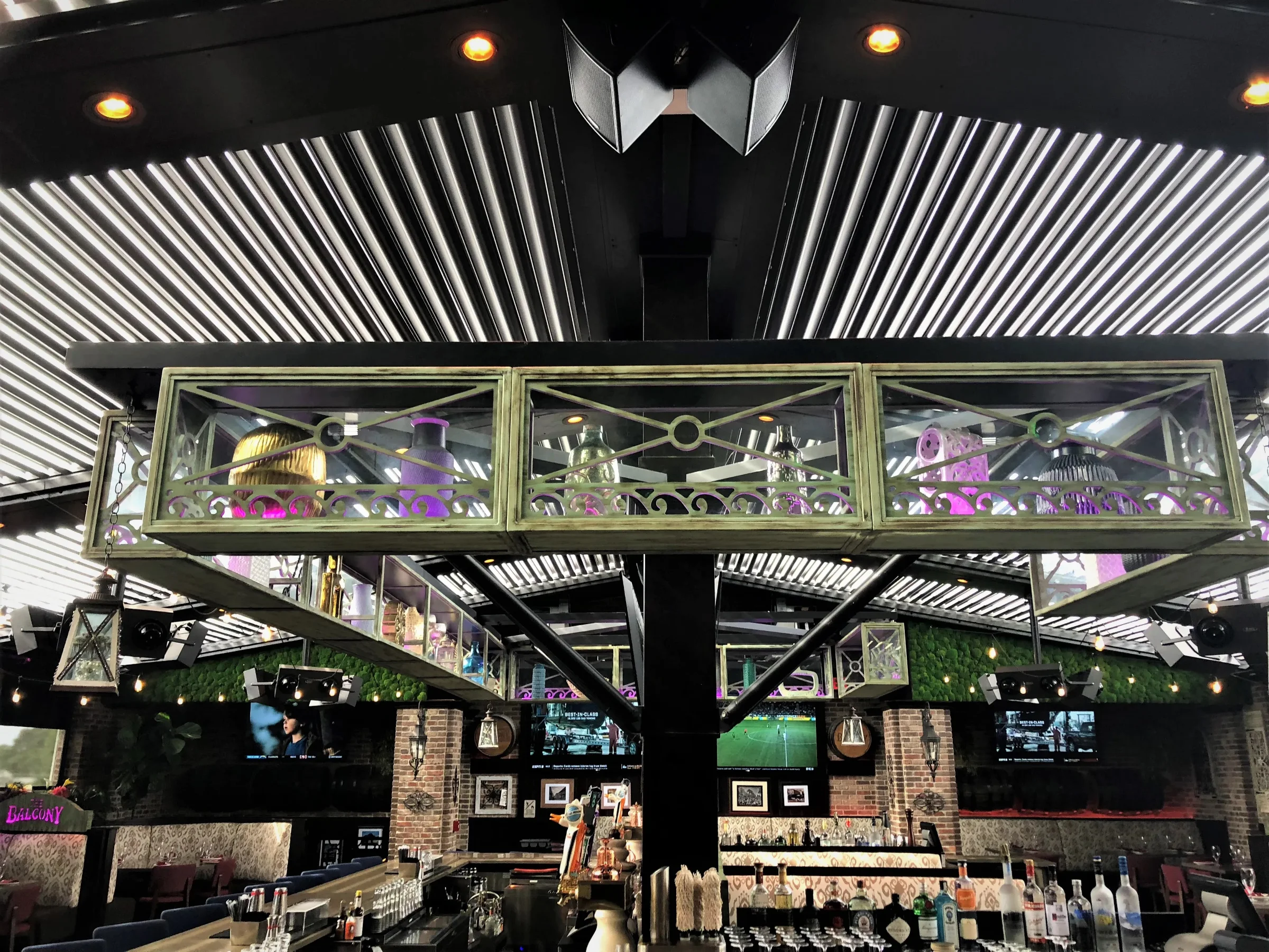 Tiki hut vs pergola: louvered aluminum roof with integrated lighting over a Fort Lauderdale bar patio