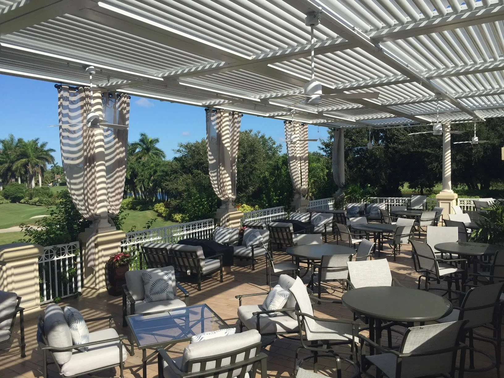 StruXure louvered pergola at the Grey Oaks Estuary country club patio in Naples, Florida