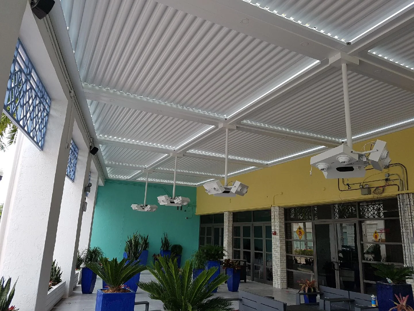 Engineered aluminum pergola structure installed over a Florida courtyard entrance