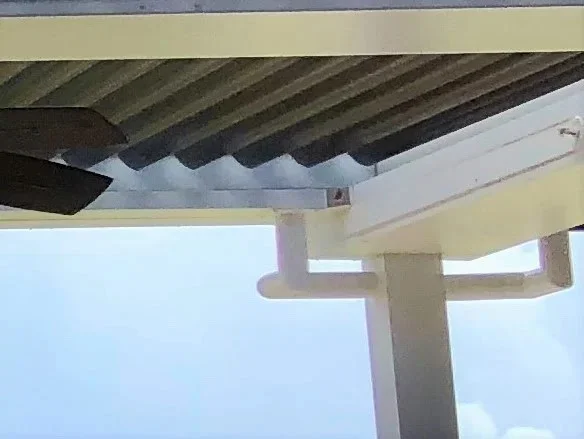 White louvered roof structure above a covered terrace at a Jupiter, Florida country club