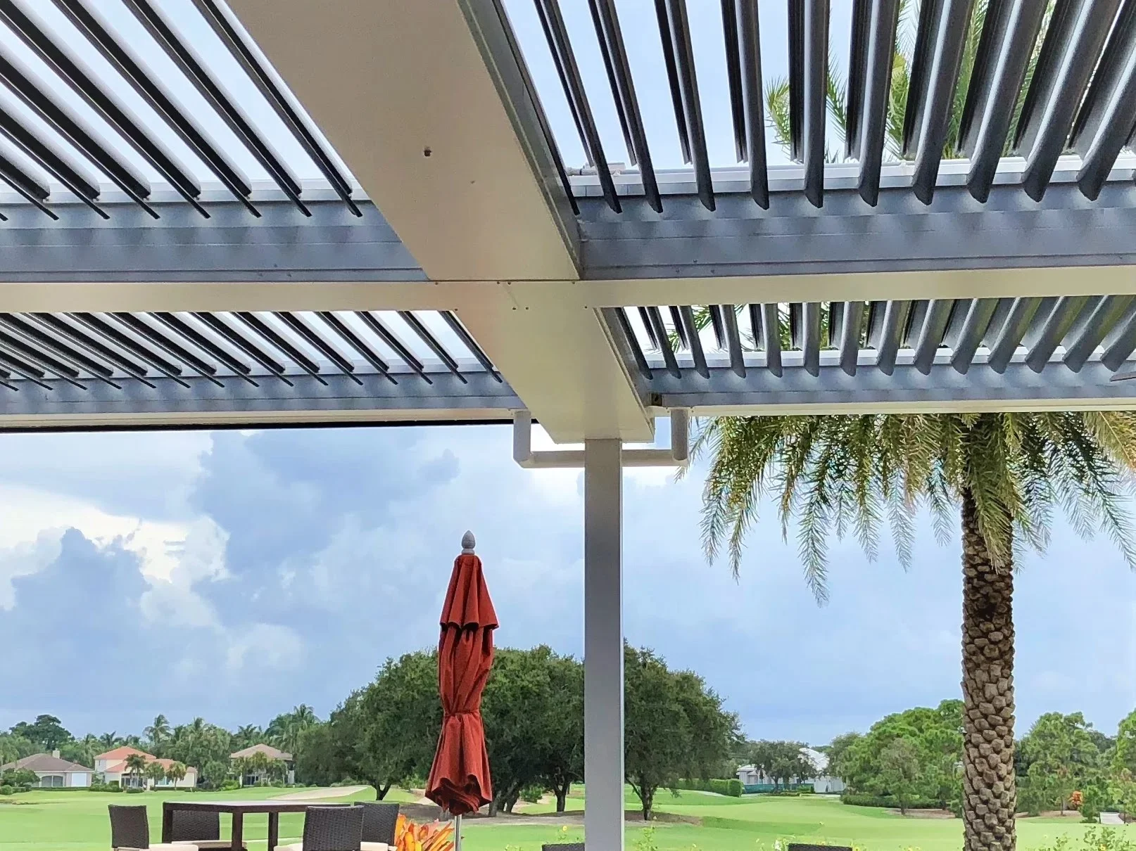 StruXure louvered pergola at Admirals Cove Country Club waterfront terrace with marina views