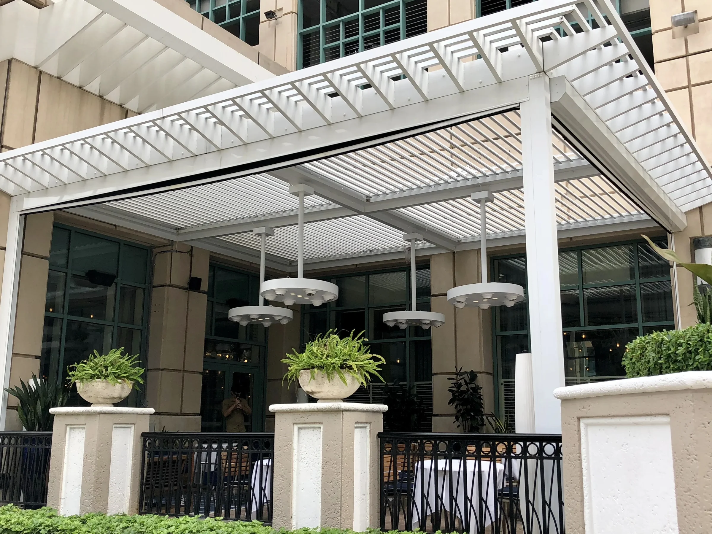 Motorized screens retracted into the header of an existing covered patio in Fort Lauderdale
