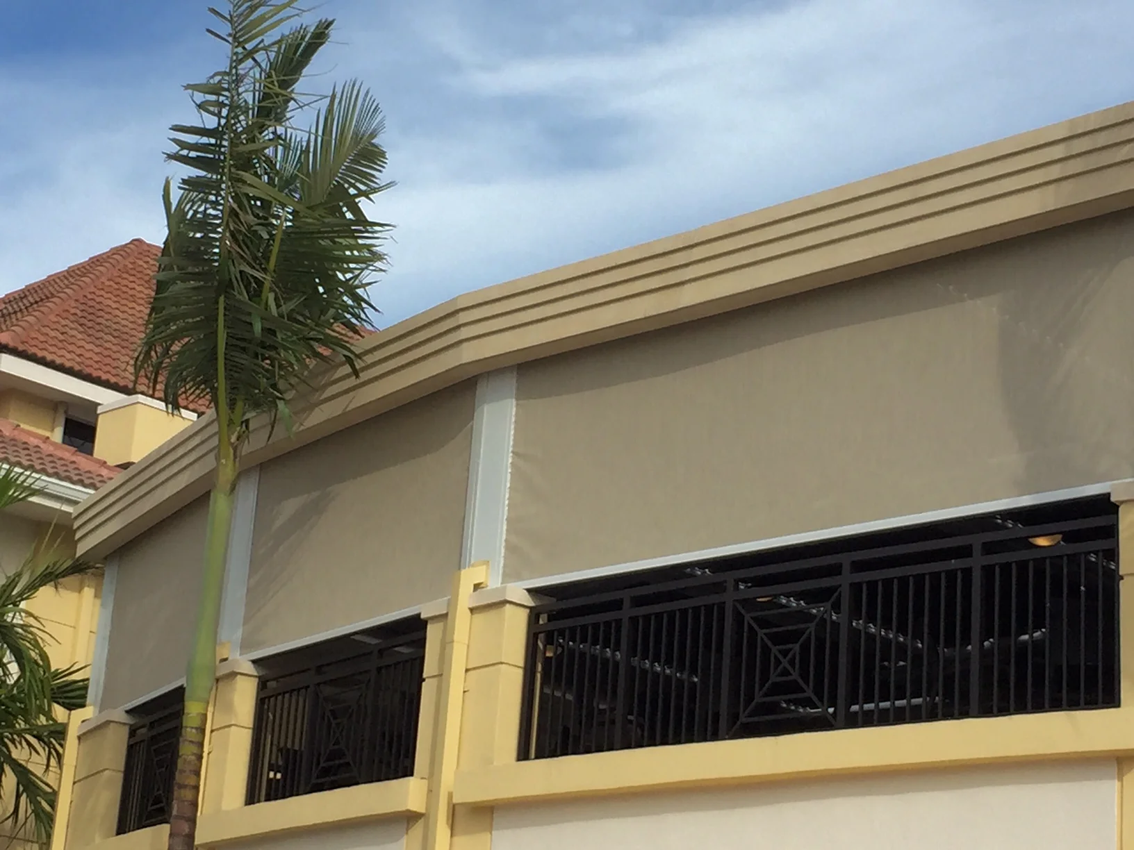 Aluminum louvered structure integrated along a clubhouse facade at a South Florida country club