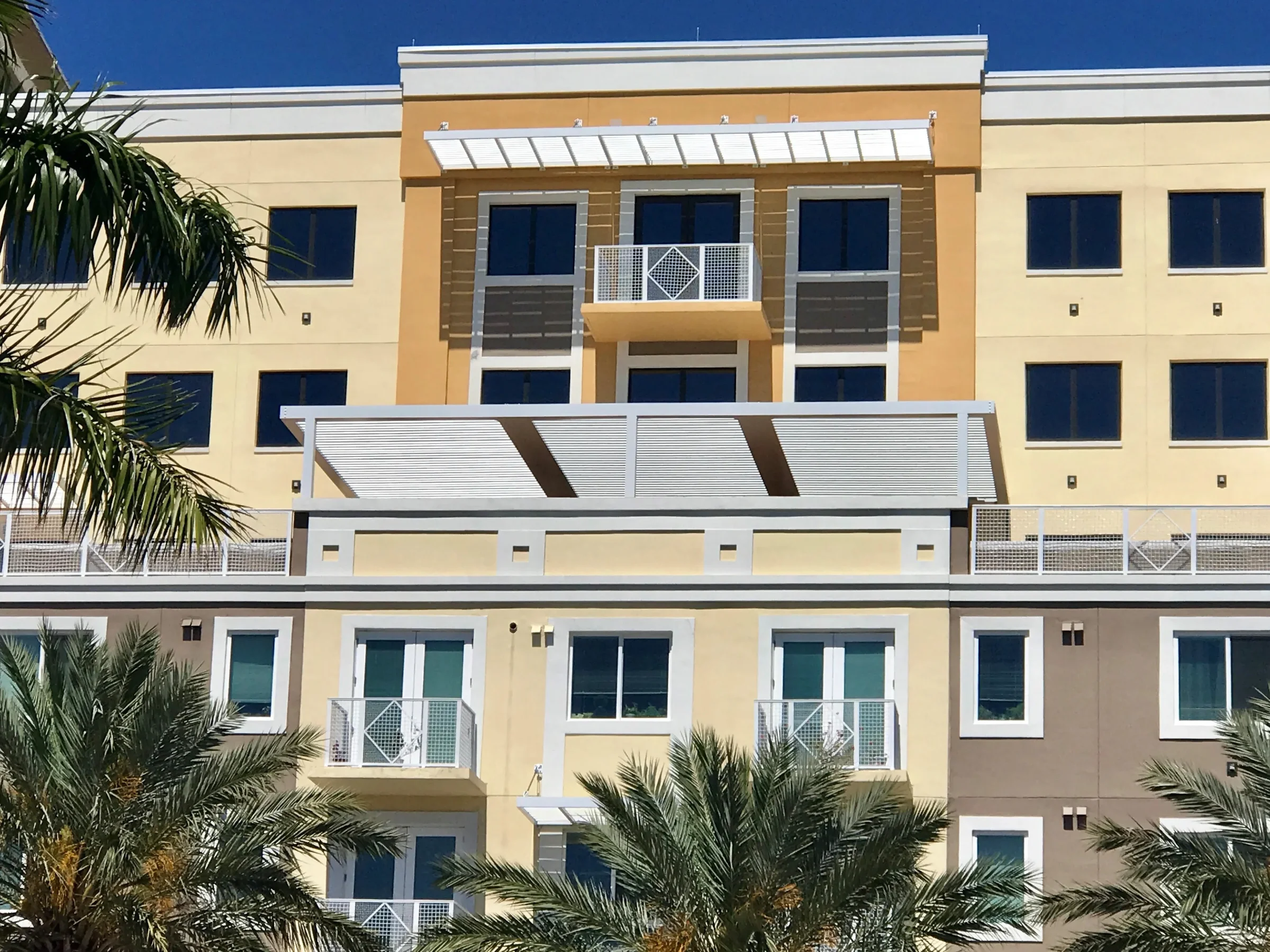 Senior living pergolas shading terraces on a South Florida residential community building