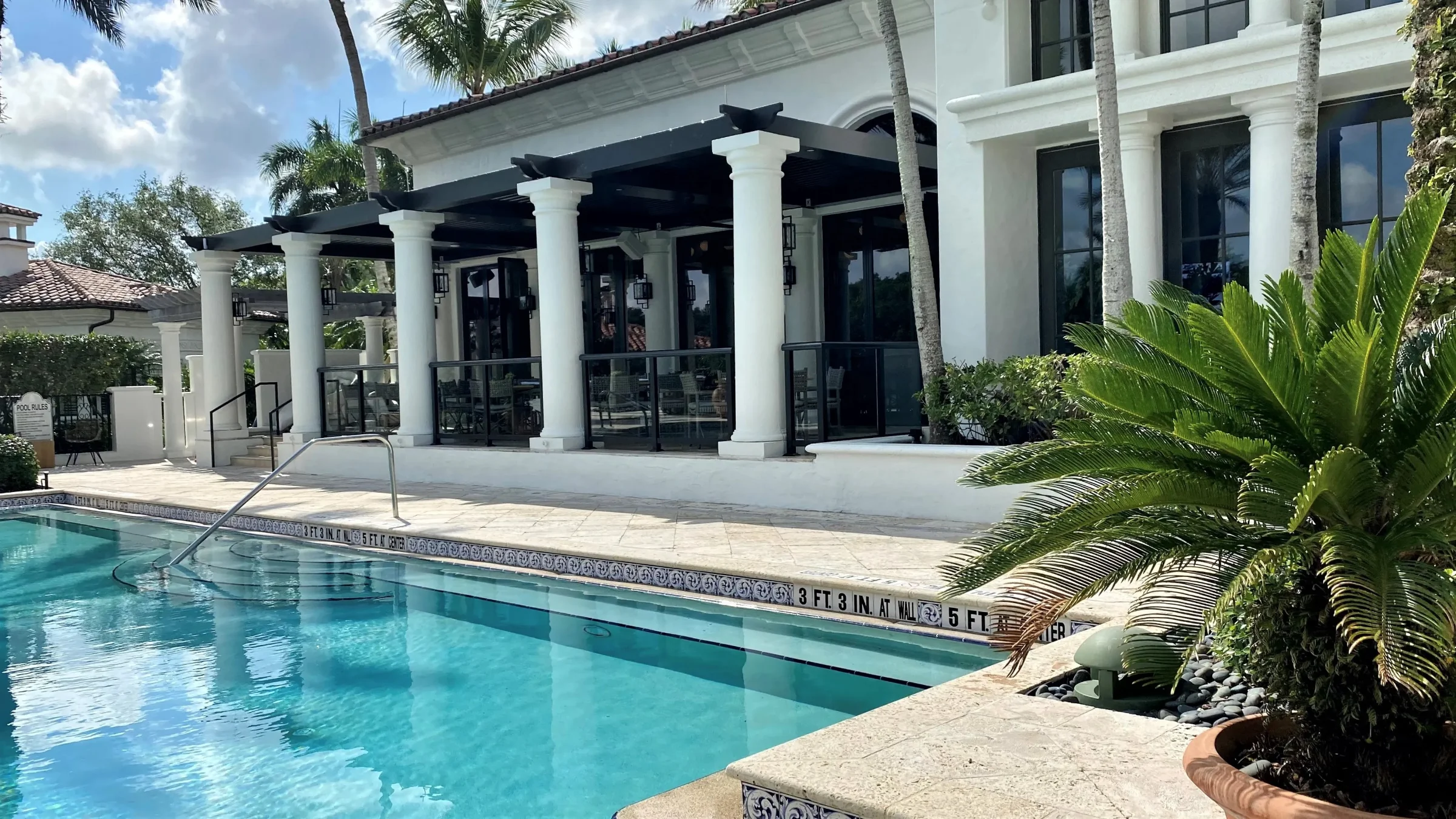 Luxury community pool amenity area at Old Palm Country Club with StruXure shade structures