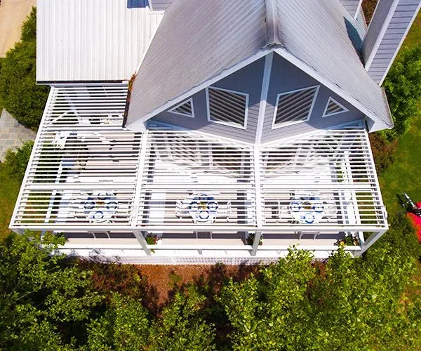 Aerial top-down drone view of a white StruXure louvered pergola covering a Florida home patio