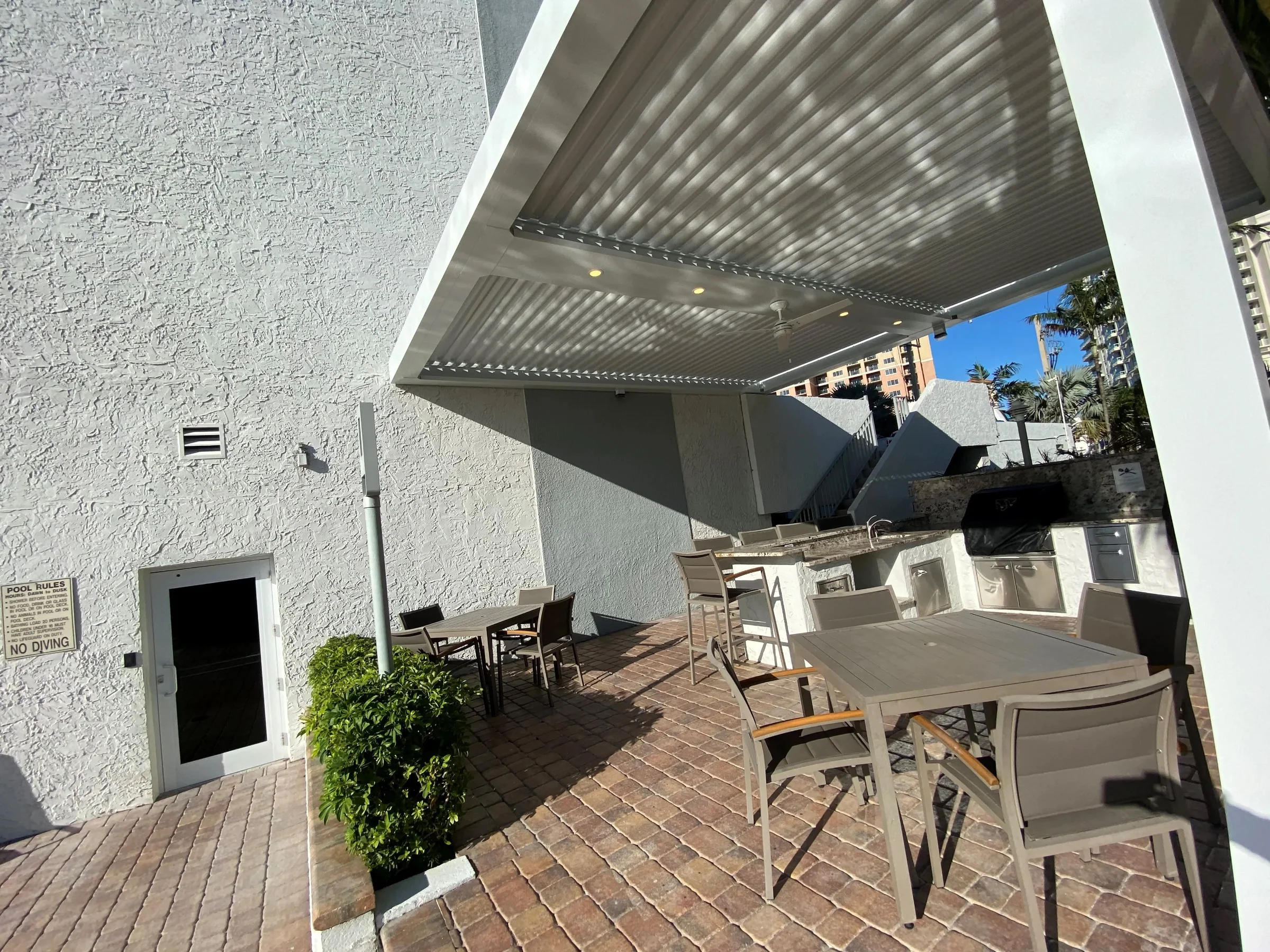Underview of charcoal StruXure louvered pergola installed by pergola builders in Miami showing precise louver alignment