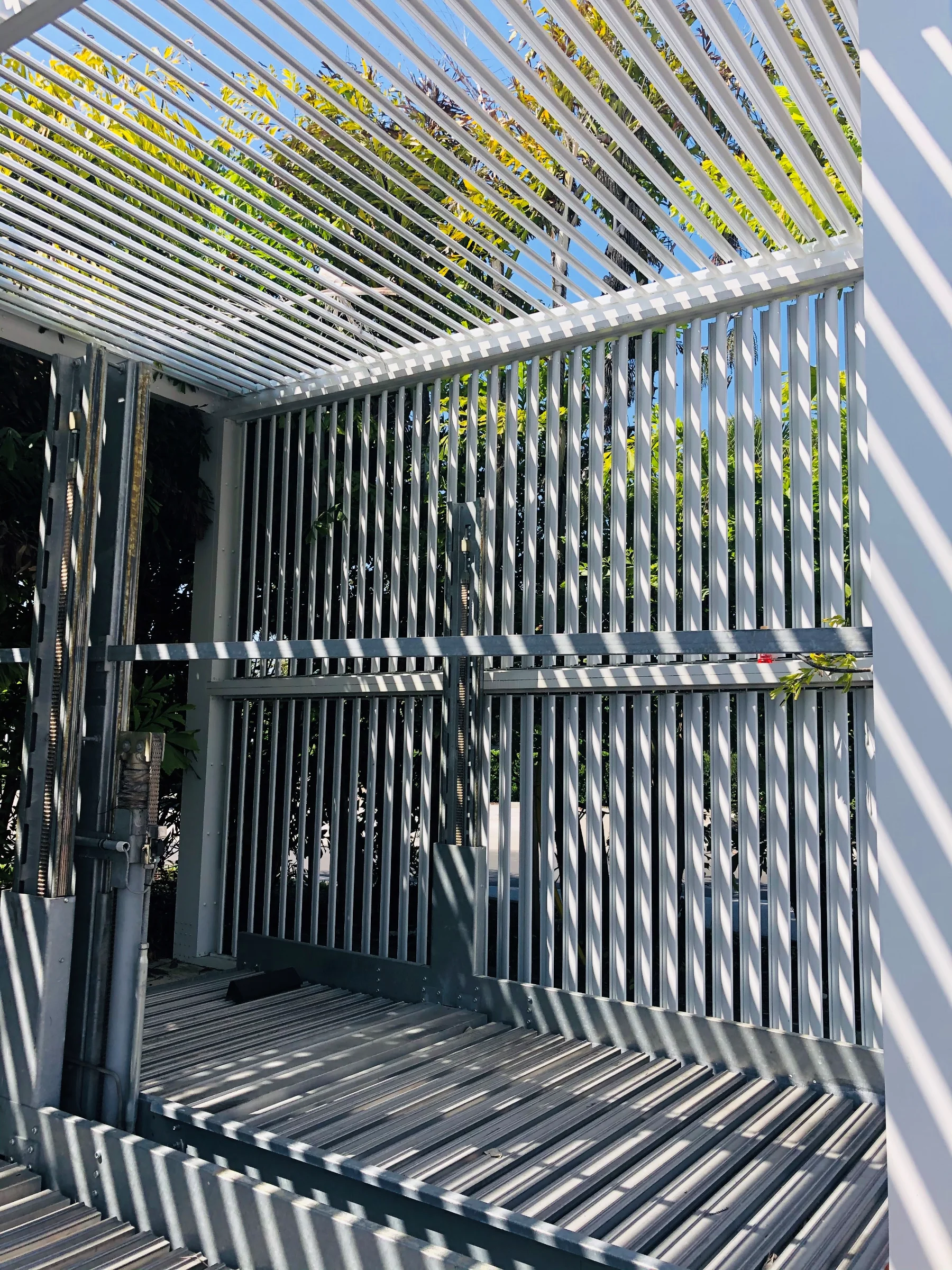 Close-up of white StruXure louvered pergola corner showing aluminum construction quality from expert Miami pergola builders