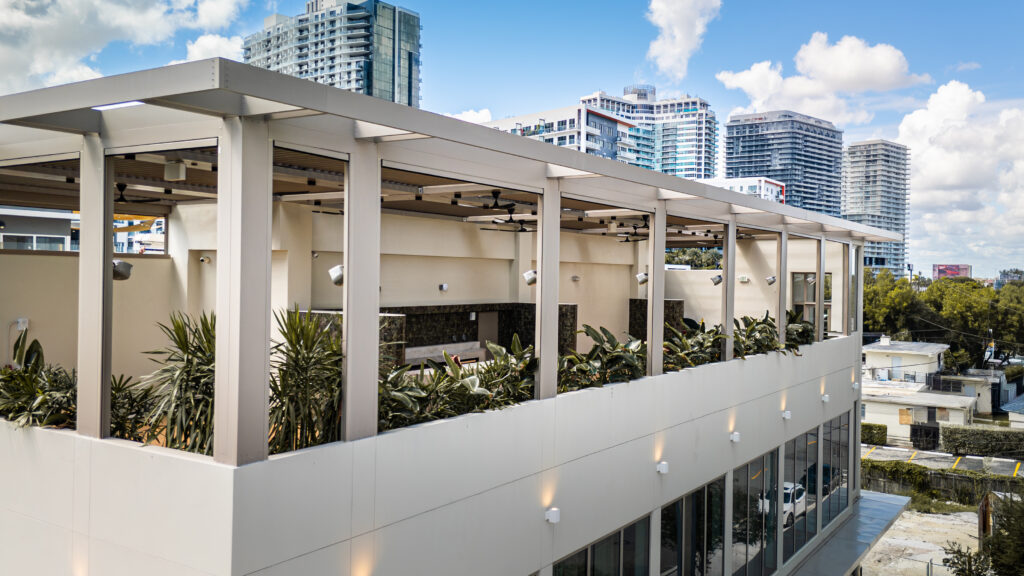 Aerial view of a hurricane-rated aluminum louvered pergola over a South Florida pool deck