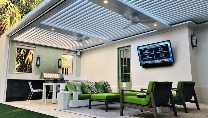 Covered backyard seating under louvered roof